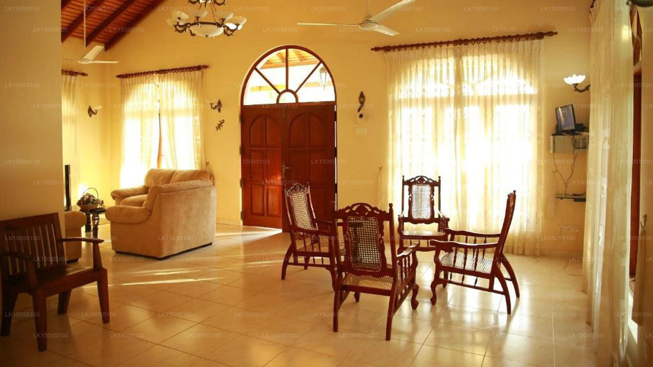 Living room with wooden furniture and large windows