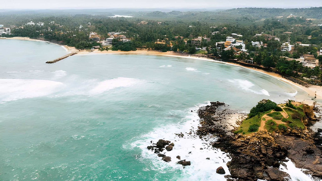 Aerial view of a coastal area with turquoise waters and rocky shores.